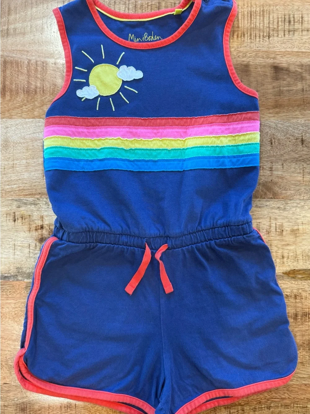 Mini Boden Navy Romper with Rainbow Stripes and Sun Appliqué